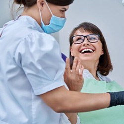 Patient and dental team member looking at X-ray