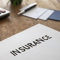 Insurance document next to calculator