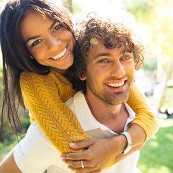 Smiling couple hugging after dental bonding