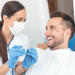 dentist showing ClearCorrect braces to a patient