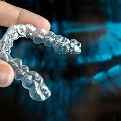 person holding a ClearCorrect aligner
