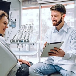 dentist showing a tablet to a patient