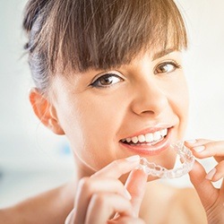 Woman placing ClearCorrect aligner