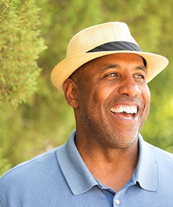 Man in blue shirt smiling with dentures in Assonet