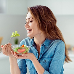 woman eating healthy for dental implant care in Assonet