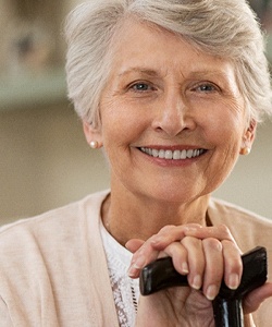 Smiling senior woman with dental implant retained dentures