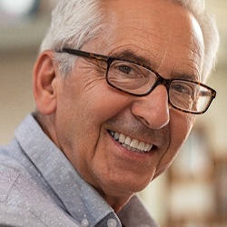 Smiling senior man with dental implant denture