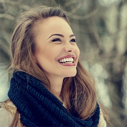 Beautiful woman with porcelain veneers smiling