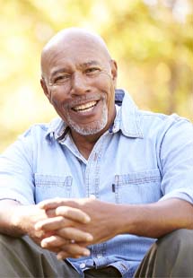 Older man receiving dental exam after replacing missing teeth