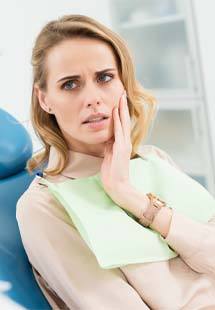 Woman talking to dentist about tooth pain