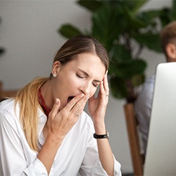 Woman tired at work before sleep apnea treatment