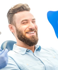 Man admiring his smile after visiting Assonet cosmetic dentist
