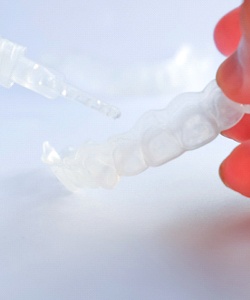Closeup of patient using at-home teeth whitening in Assonet