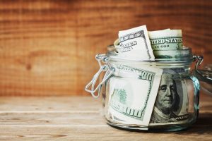 jar of money sitting on a counter