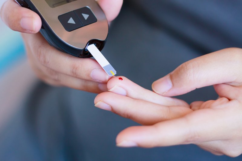 Person with diabetes checking her blood sugar levels