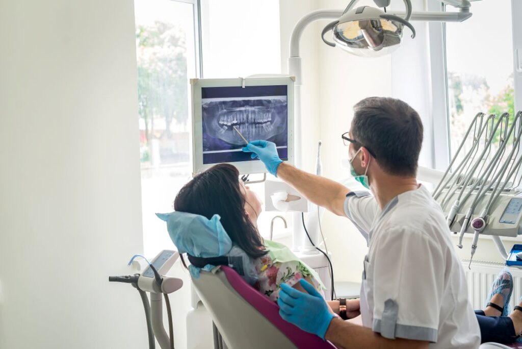 A woman reviewing dental x-rays with her dentist