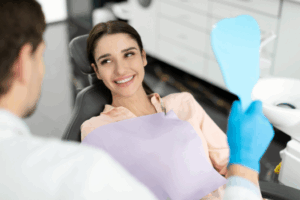 a dentist smiling and helping a patient