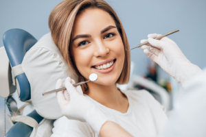a patient smiling during a dental checkup and cleaning
